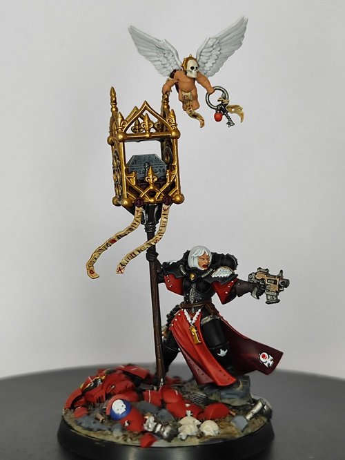 Battle Sister protecting a fallen Blood Angel